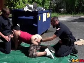 Two police officers of different races engage in hot gay sex in the parking lot.