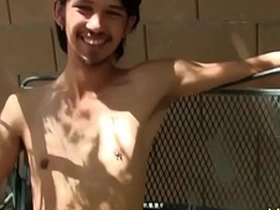 Young Asian man masturbates outdoors.