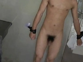 Gay BDSM scene with an Asian slave boy being punished and pleasured.